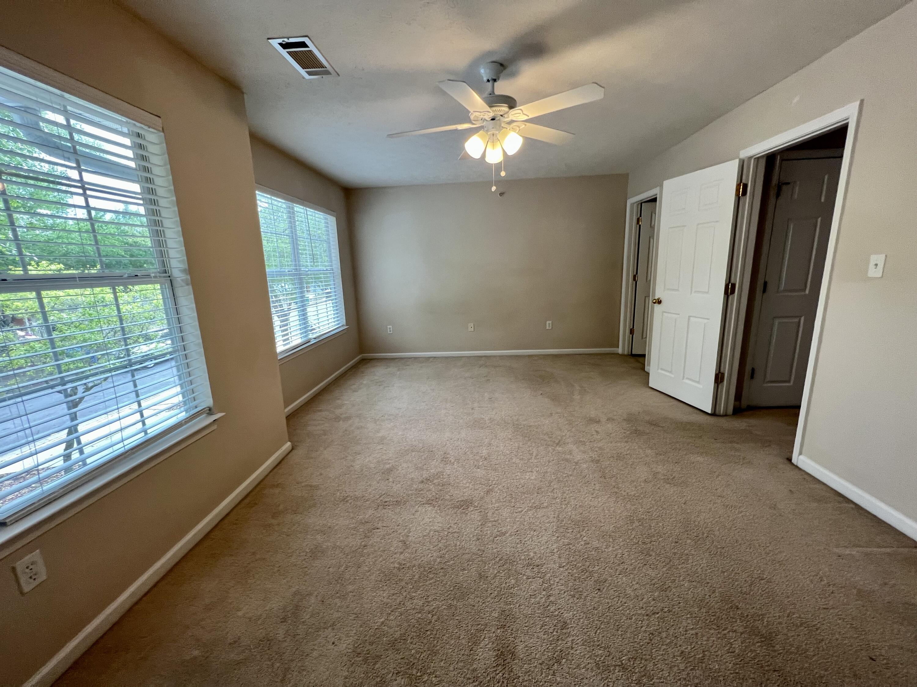308 Crooked Pine Trail Crestview, FL 32539 - Photo 15 of 20 an empty room with windows and chandelier fan