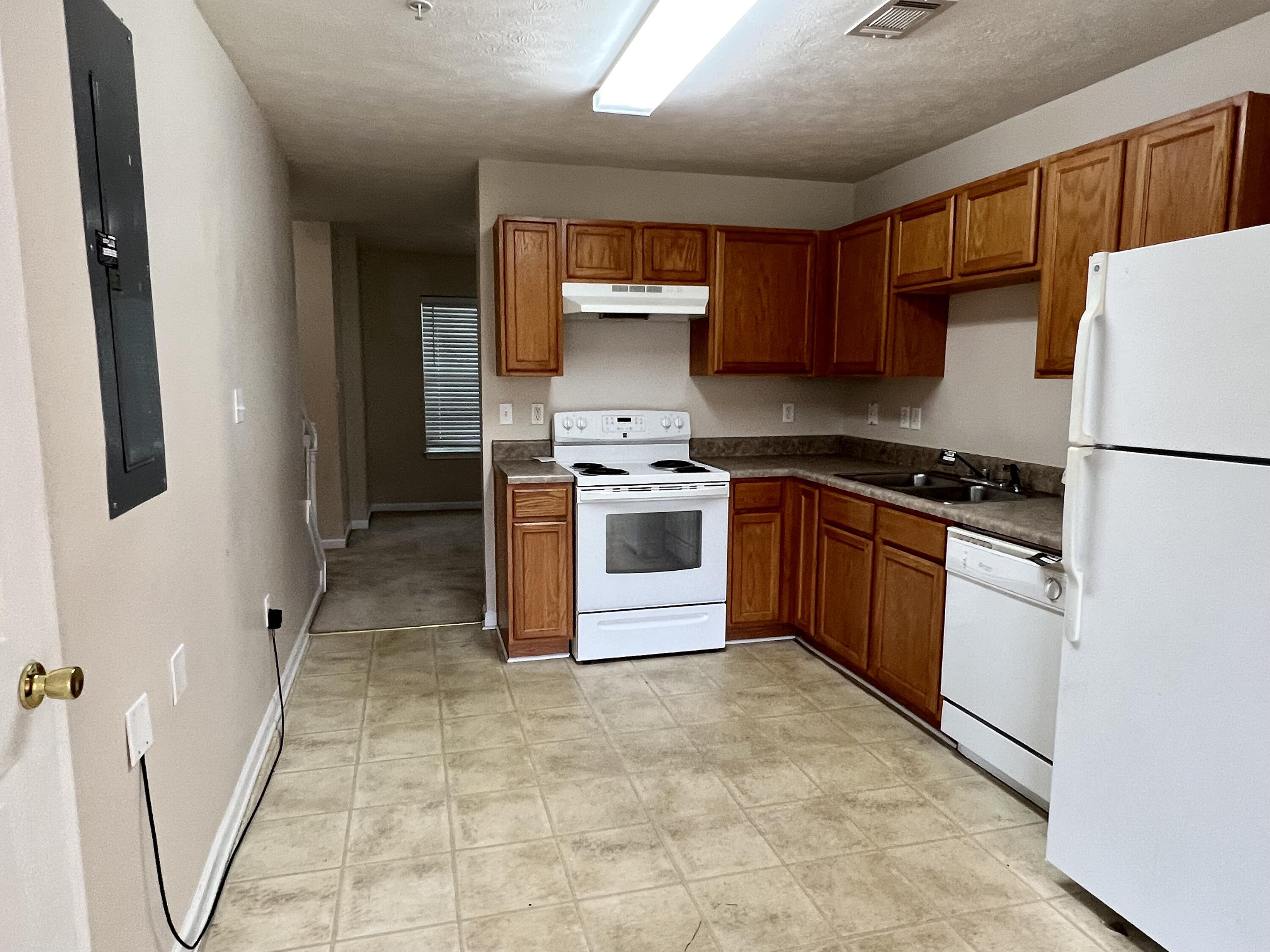 308 Crooked Pine Trail Crestview, FL 32539 - Photo 4 of 20 a kitchen with a stove sink and refrigerator
