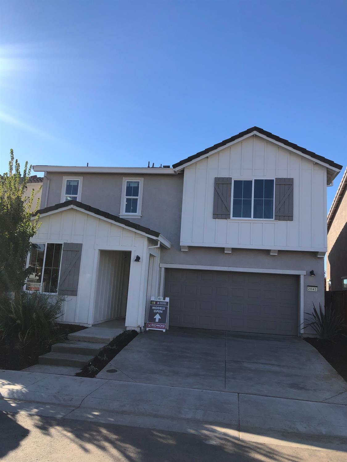 a front view of a house with a garage