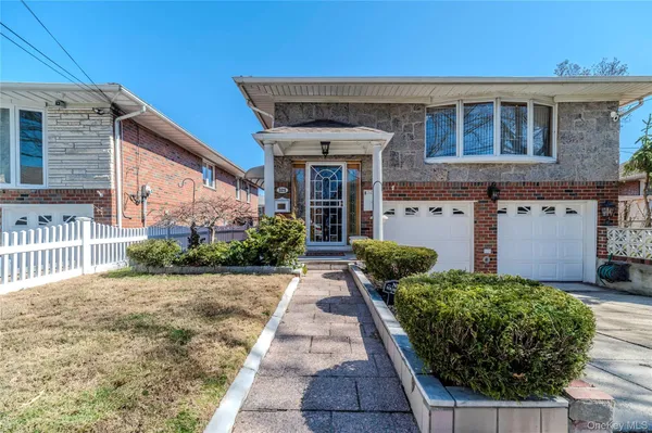 a front view of a house with garden