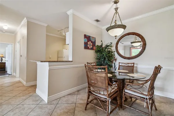 a view of a dining room with furniture and a chandelier