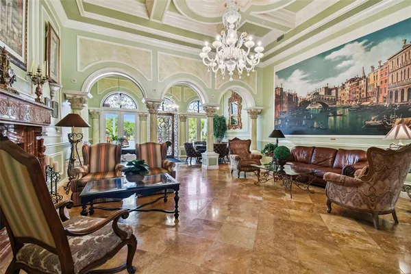 a living room with fireplace furniture and a chandelier