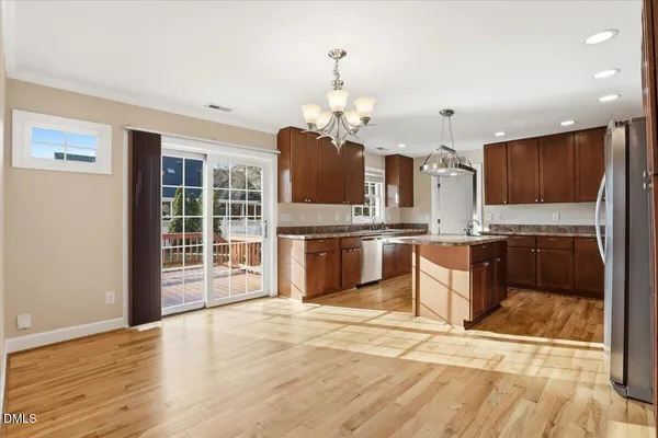 a kitchen with stainless steel appliances granite countertop a sink stove and refrigerator