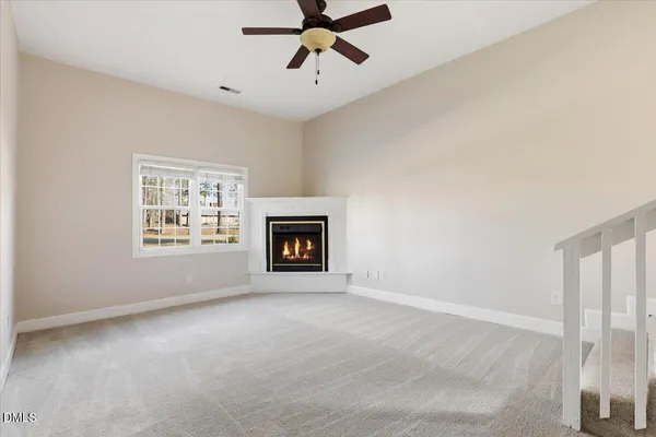 a view of empty room with fireplace