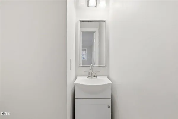 a bathroom with a sink toilet and a mirror
