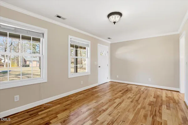 wooden floor in an empty room with a window