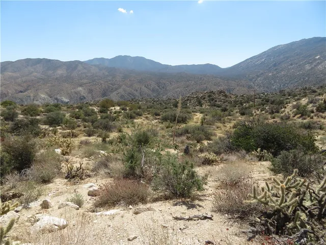 a view of a large building with a mountain in the background