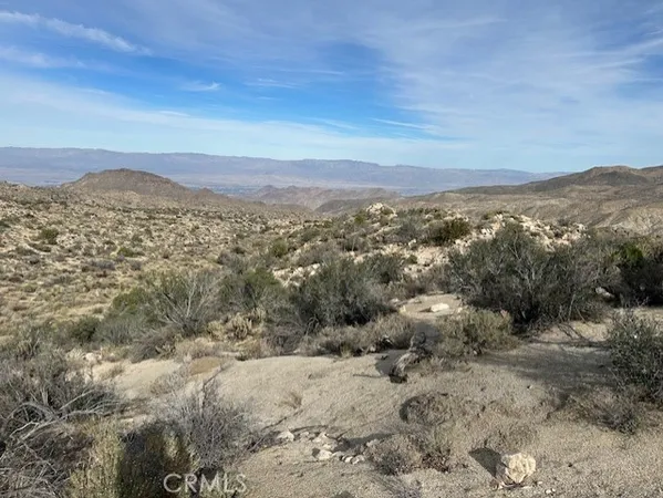 a view of a large mountain with mountains in the background