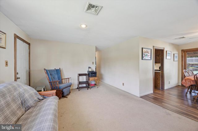 a bed room with furniture and a chair