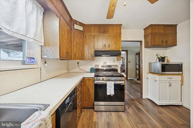 a kitchen with a stove a sink and a refrigerator