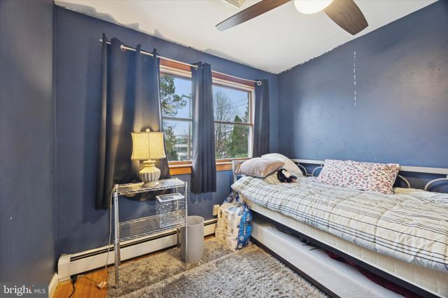 a bed sitting in a bedroom next to a window