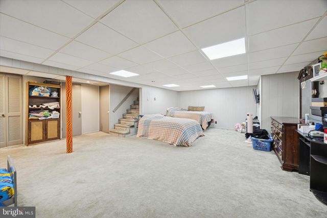 a large room with a lot of bed and a couch