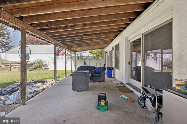 a view of a patio with table and chairs and potted plants