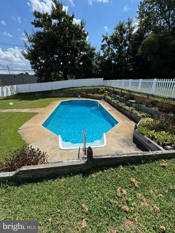 a view of a swimming pool and lounge chairs