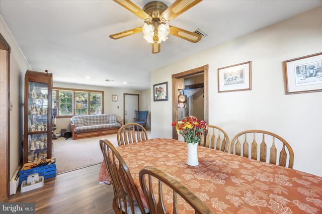 a view of a dining room with furniture and a chandelier