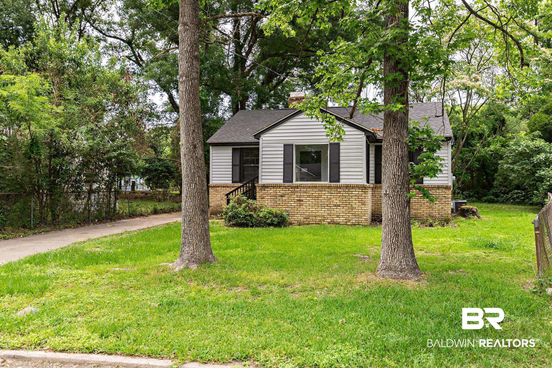 1869 Mott Drive West Mobile, AL 36617 - Photo 3 of 34 View of front facade featuring a chimney, a front yard, brick siding, and roof with shingles