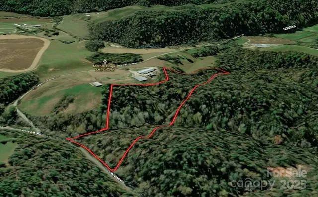 an aerial view of a golf course with a lake view