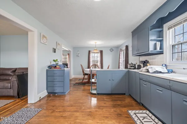 a kitchen with cabinets and window