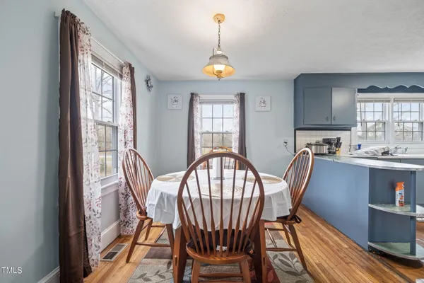 a view of a dining room with furniture window and wooden floor