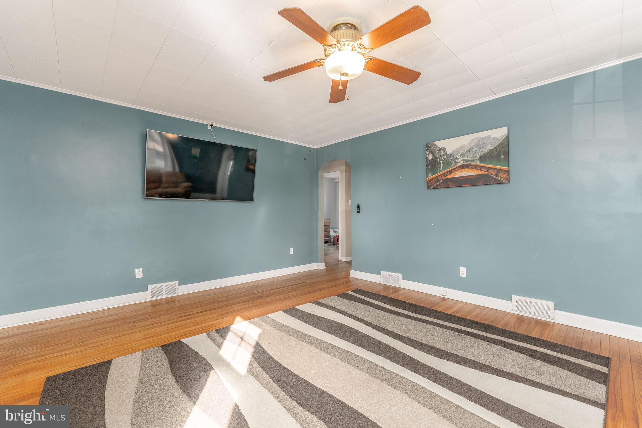 501 W Road Ridley Park, PA 19078 - Photo 5 of 29 a bedroom with a large bed and a flat screen tv