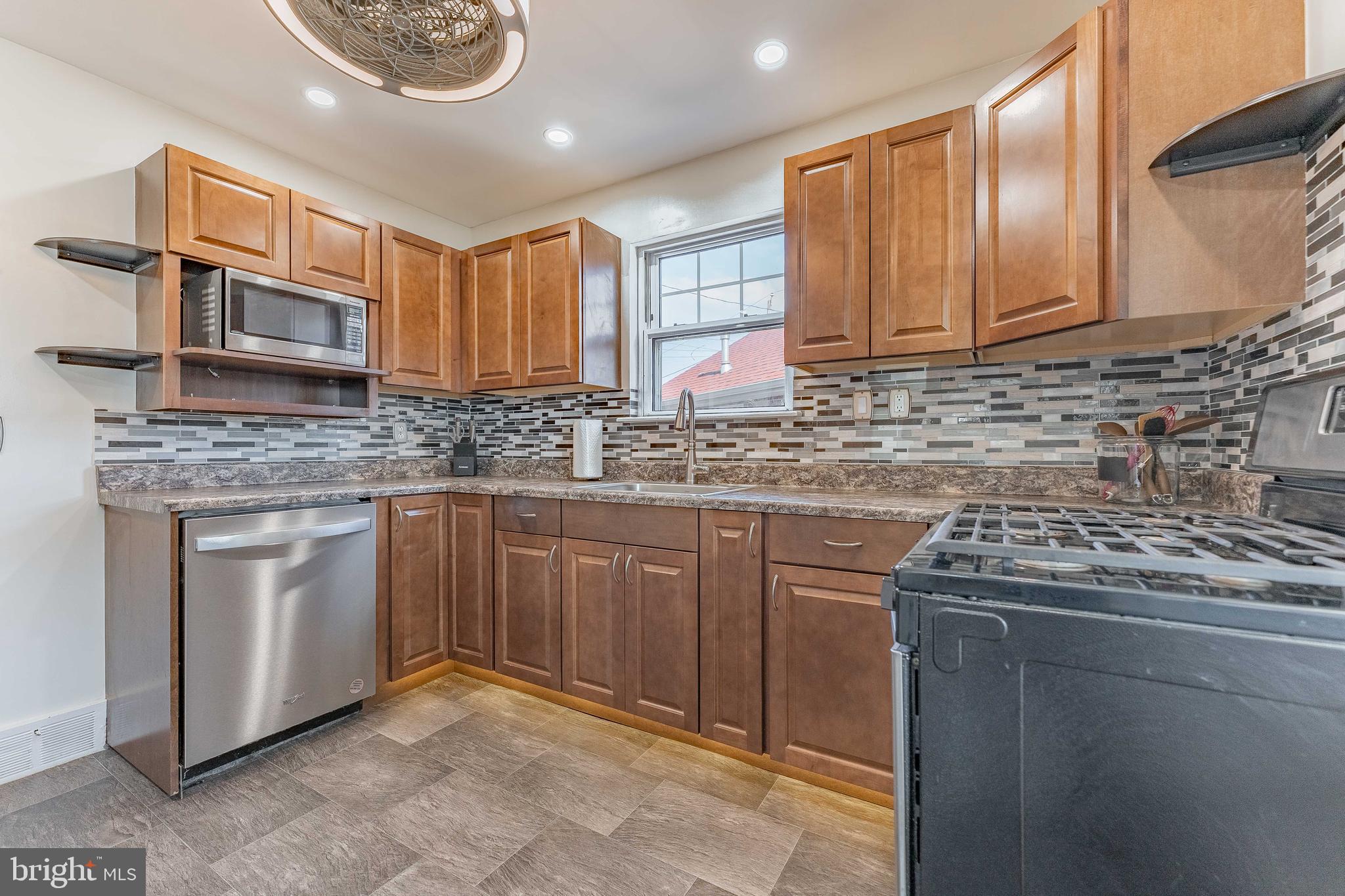 501 W Road Ridley Park, PA 19078 - Photo 7 of 29 a kitchen with stainless steel appliances granite countertop a sink stove and cabinets