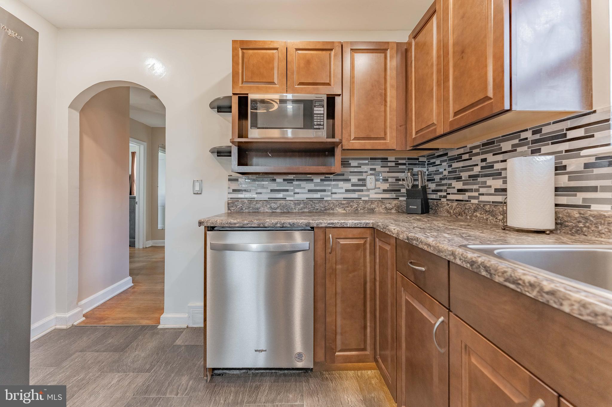 501 W Road Ridley Park, PA 19078 - Photo 8 of 29 a kitchen with stainless steel appliances granite countertop a sink a stove and cabinets