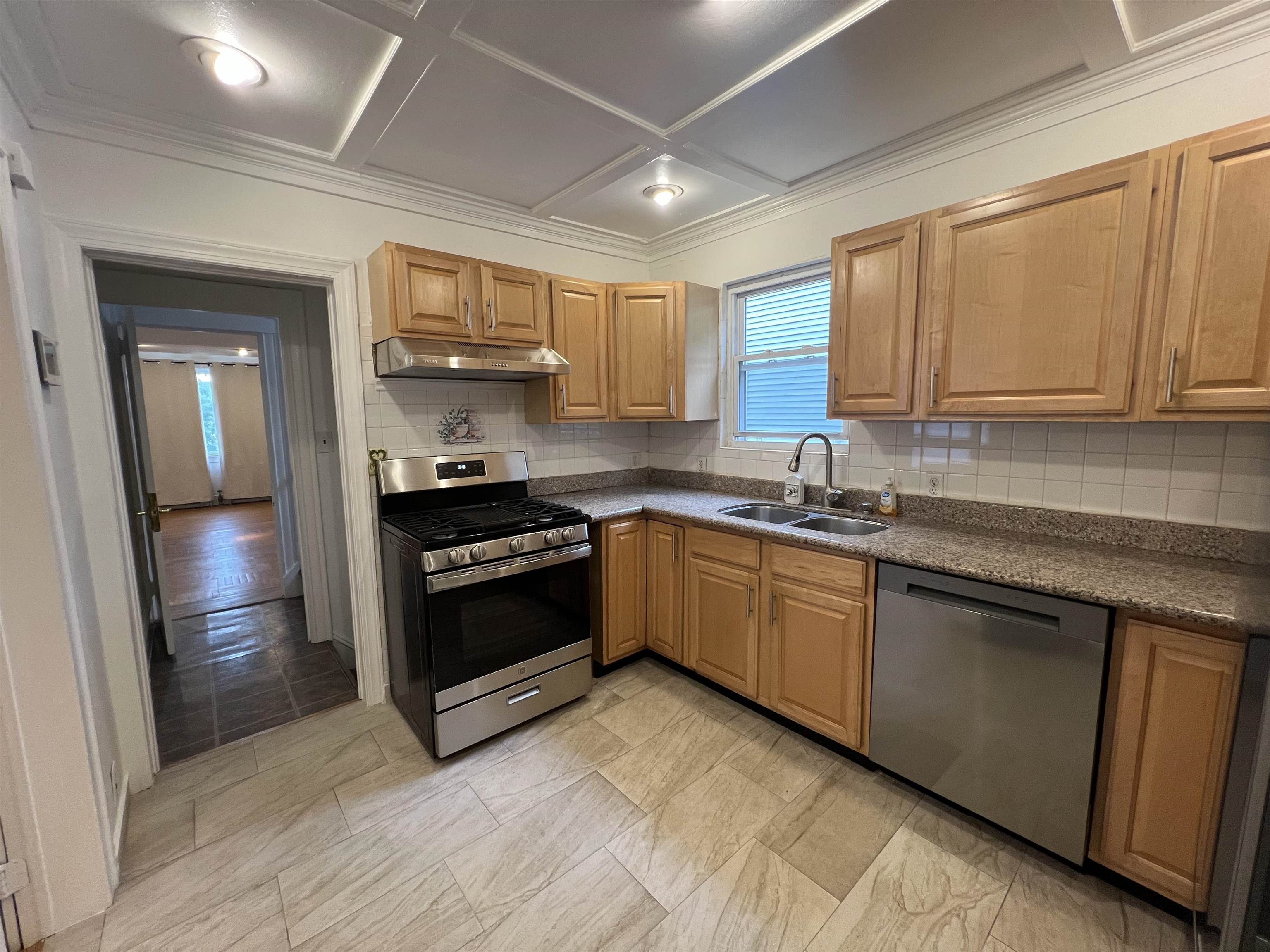 1 8th Street Ridgefield Park, NJ 07660 - Photo 14 of 27 a kitchen with stainless steel appliances granite countertop a stove a sink and a refrigerator
