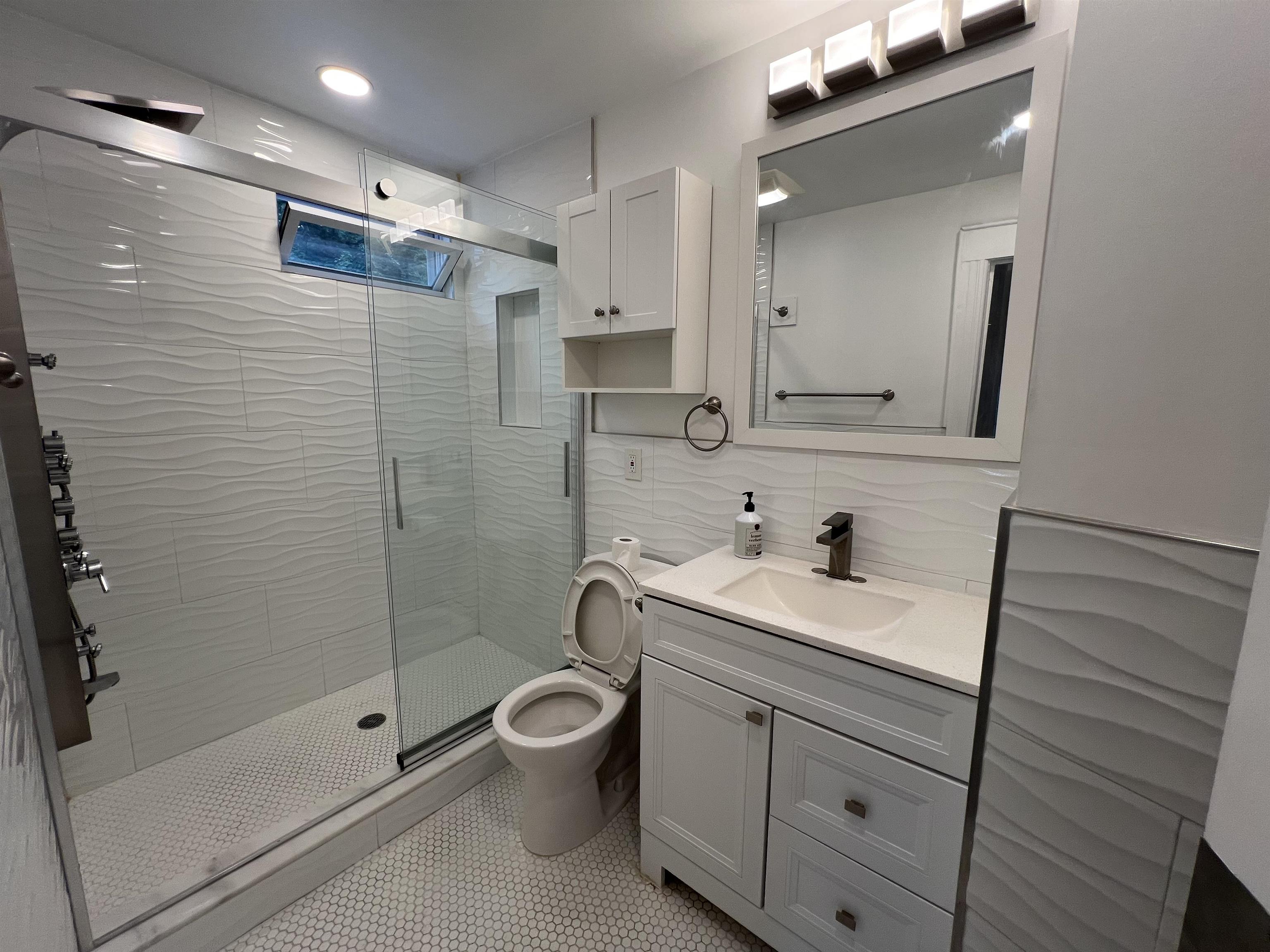 1 8th Street Ridgefield Park, NJ 07660 - Photo 18 of 27 a bathroom with a sink a toilet and shower