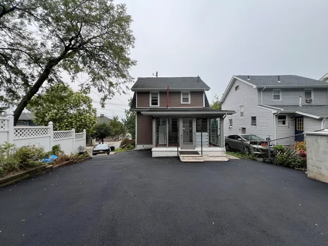 a view of a car park in front of house