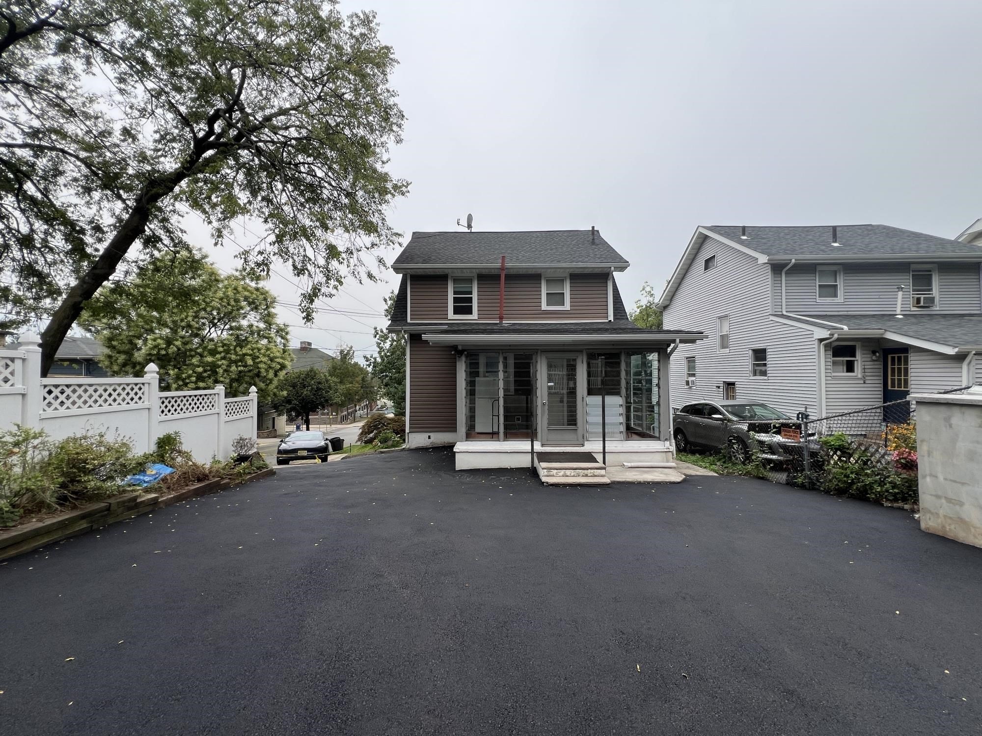 1 8th Street Ridgefield Park, NJ 07660 - Photo 3 of 27 a view of a car park in front of house