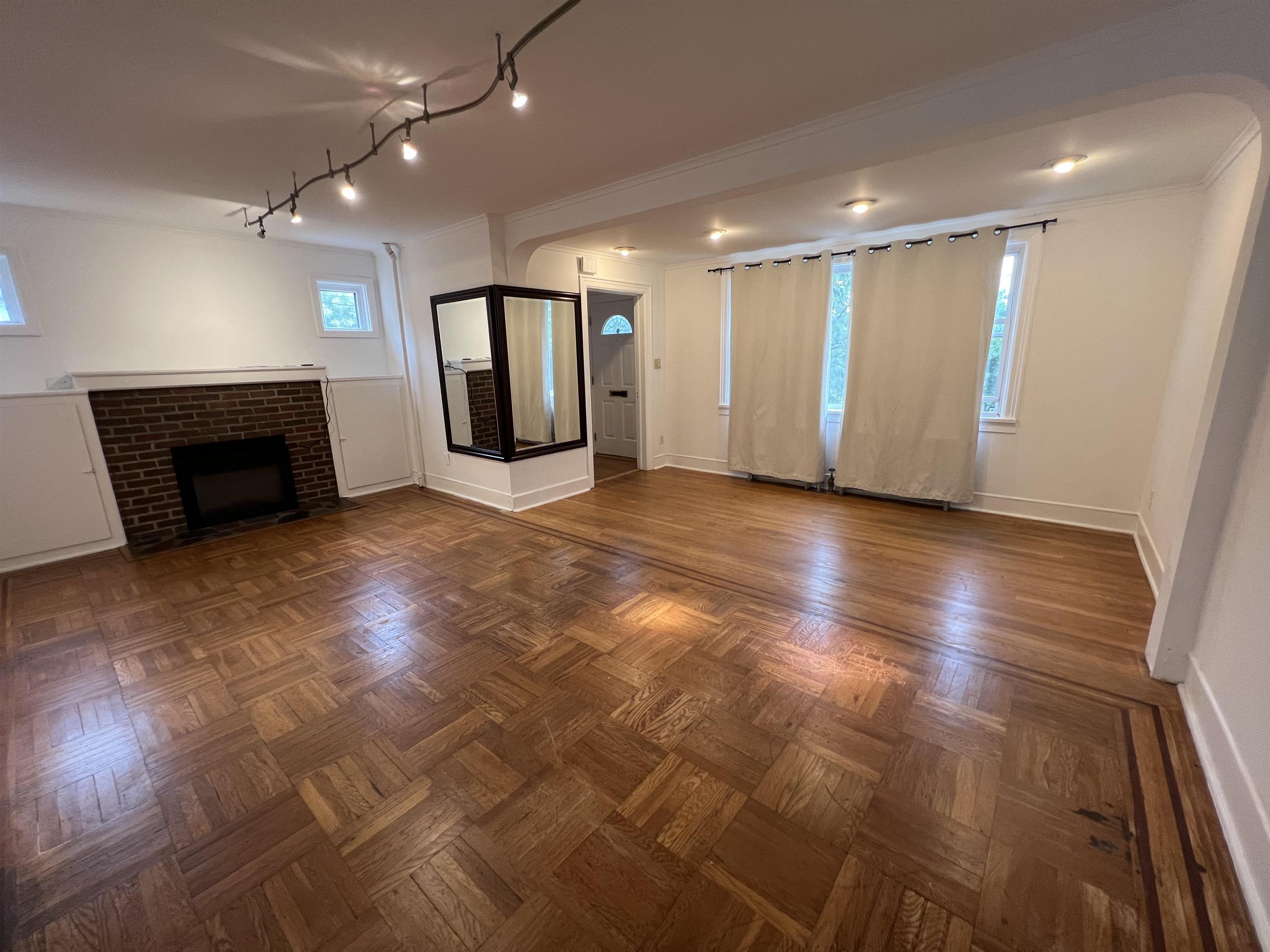 1 8th Street Ridgefield Park, NJ 07660 - Photo 7 of 27 an empty room with wooden floor fireplace and windows