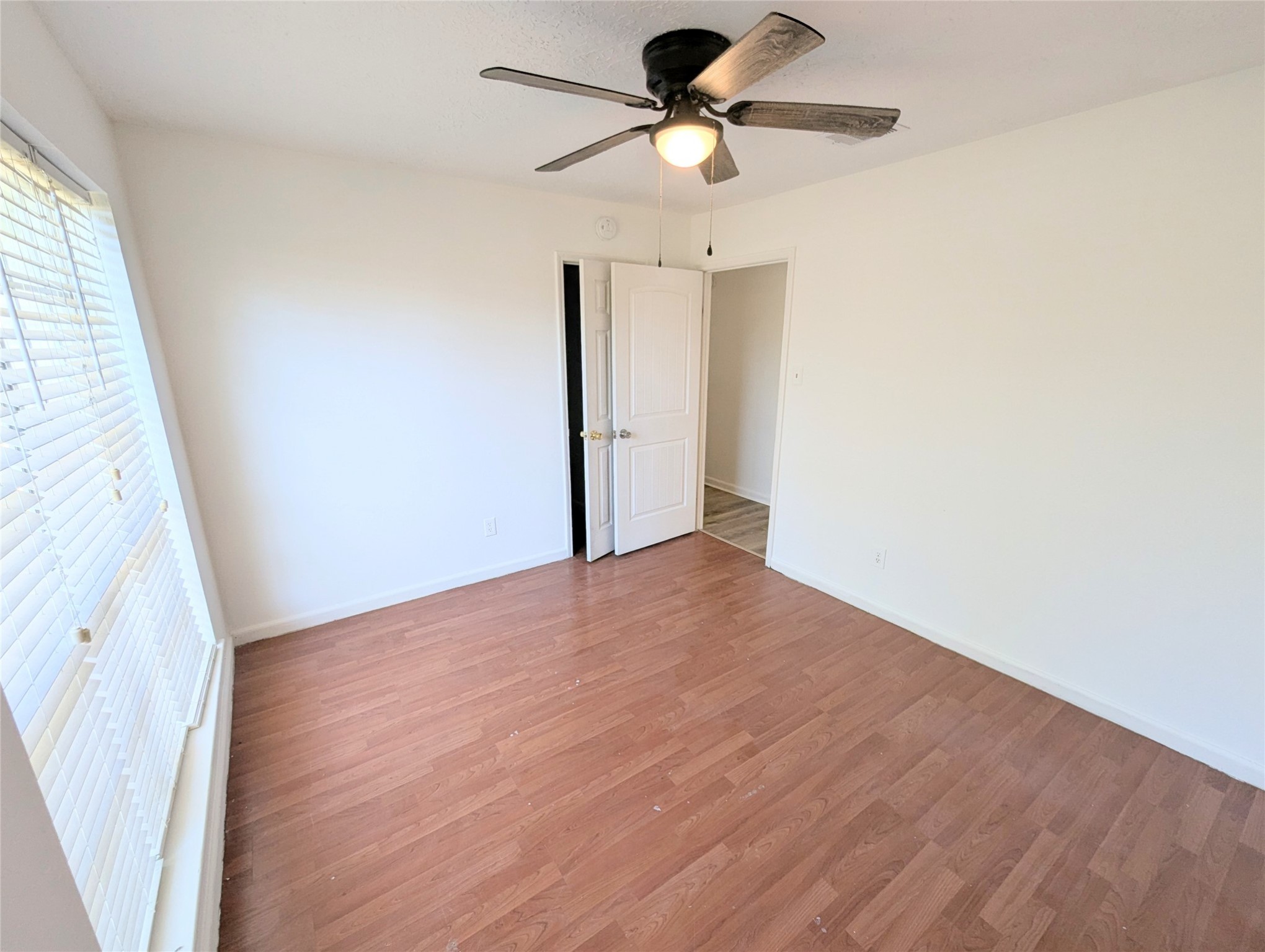 17602 Crestline Road Humble, TX 77396 - Photo 13 of 27 a view of a big room with wooden floor a ceiling fan and window