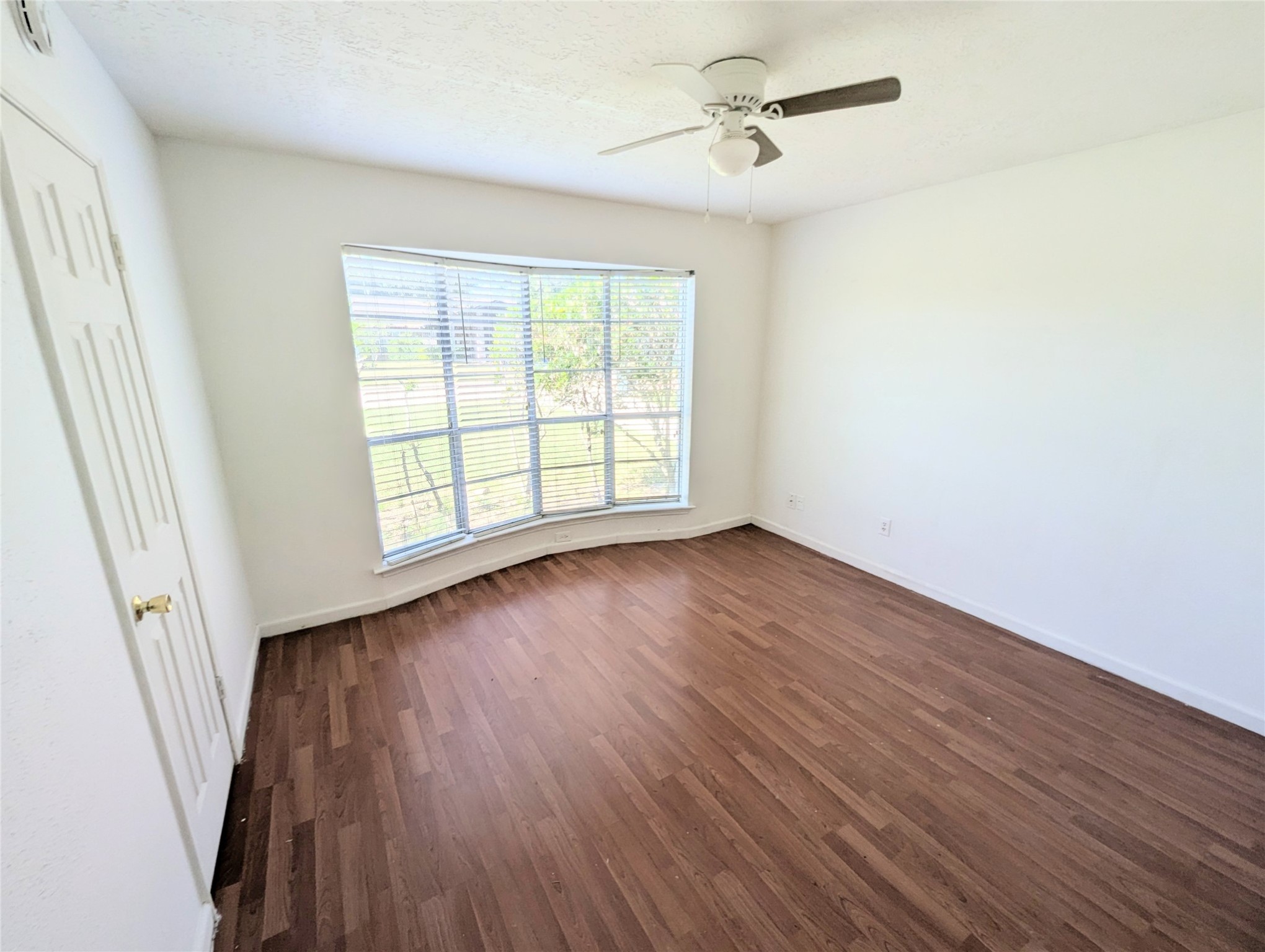 17602 Crestline Road Humble, TX 77396 - Photo 16 of 27 a view of an empty room with wooden floor and a window