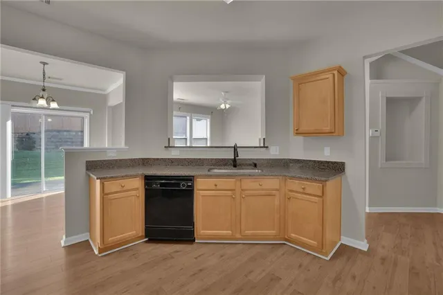 a kitchen with stainless steel appliances granite countertop a stove and cabinets