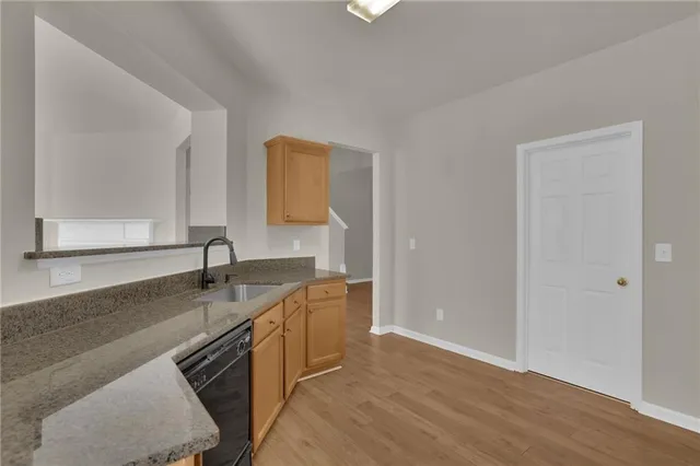 a kitchen with a sink and a refrigerator