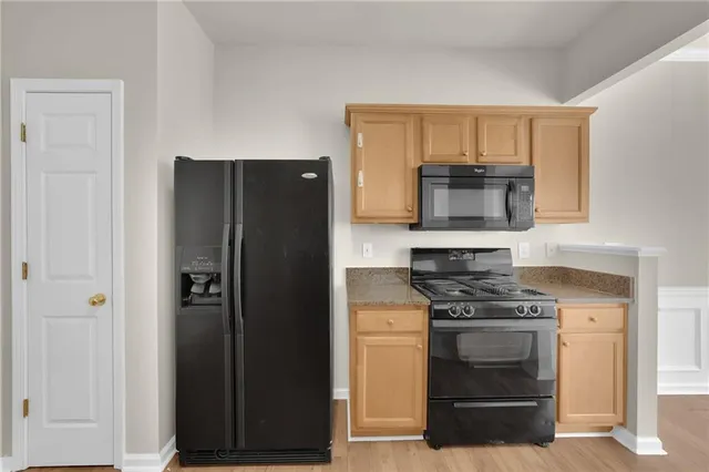 a kitchen with a refrigerator stove and microwave