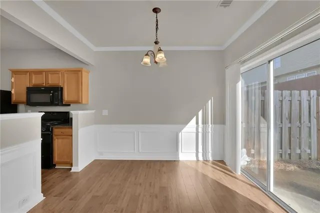 a view of a kitchen with wooden floor and a ceiling fan