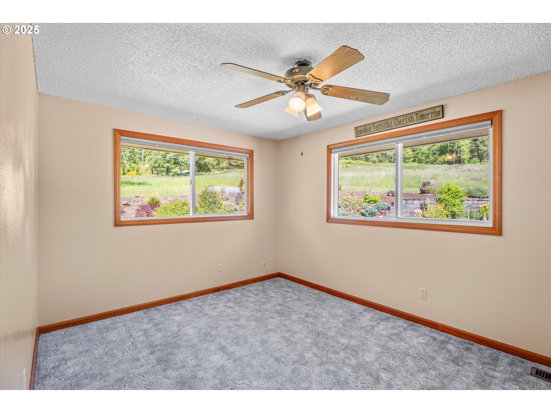 32117 Bellinger Scale Road Lebanon, OR 97355 - Photo 26 of 40 a view of an empty room with wooden floor and fan