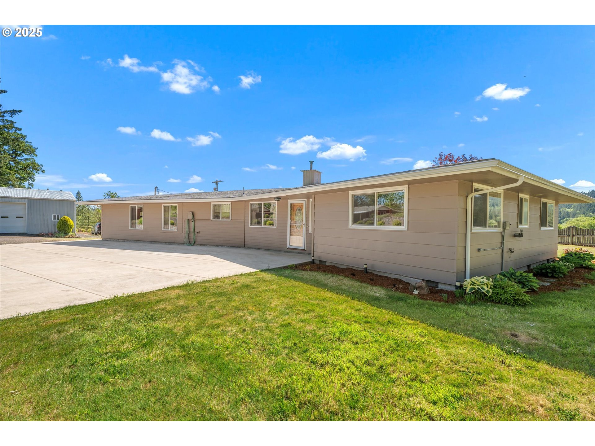 32117 Bellinger Scale Road Lebanon, OR 97355 - Photo 40 of 40 a view of a backyard with plants and a patio