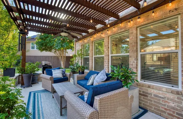 a patio with a table and chairs under an umbrella