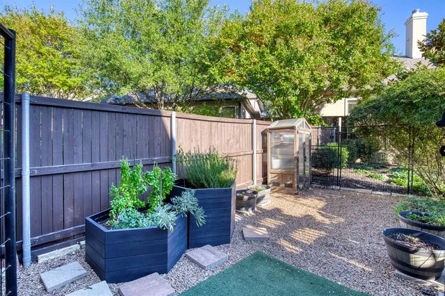 an aerial view of a house with garden space and sitting area