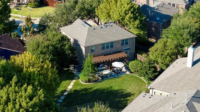 an aerial view of a house with a yard and lake view