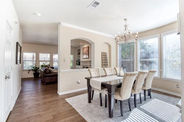 a view of a dining room with furniture wooden floor and chandelier
