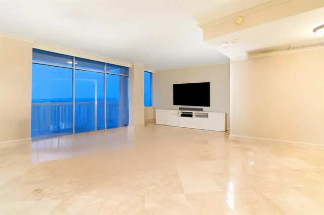 a view of a kitchen with a sink and a refrigerator