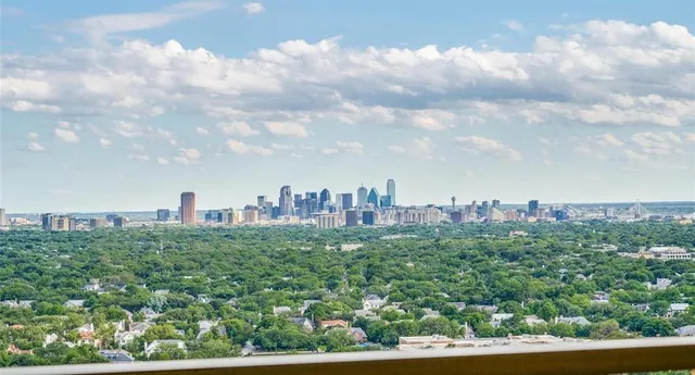 a view of a city with lush green forest