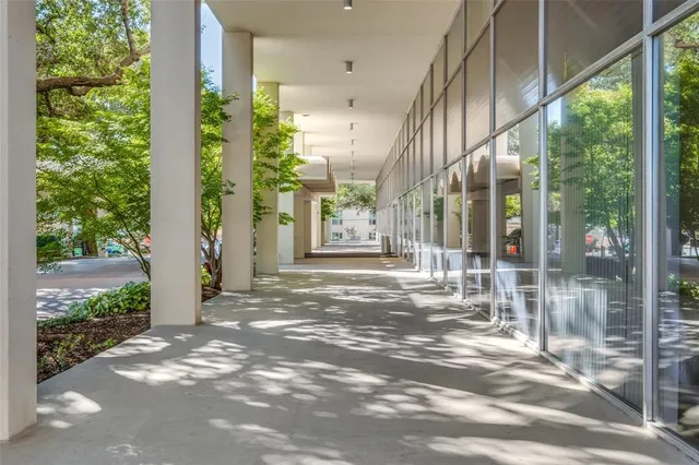 a view of a porch with a floor to ceiling window and wooden floor