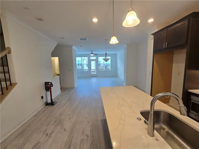 a room with wooden floor and windows