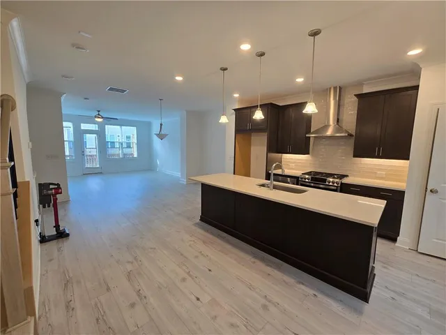 a living room with stainless steel appliances kitchen island granite countertop furniture