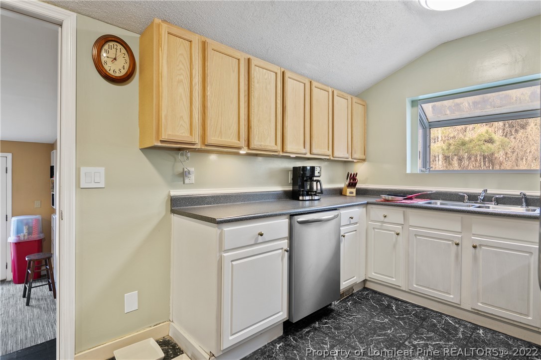 628 Tc Jones Road Raeford, NC 28376 - Photo 17 of 46 a kitchen with a sink and cabinets