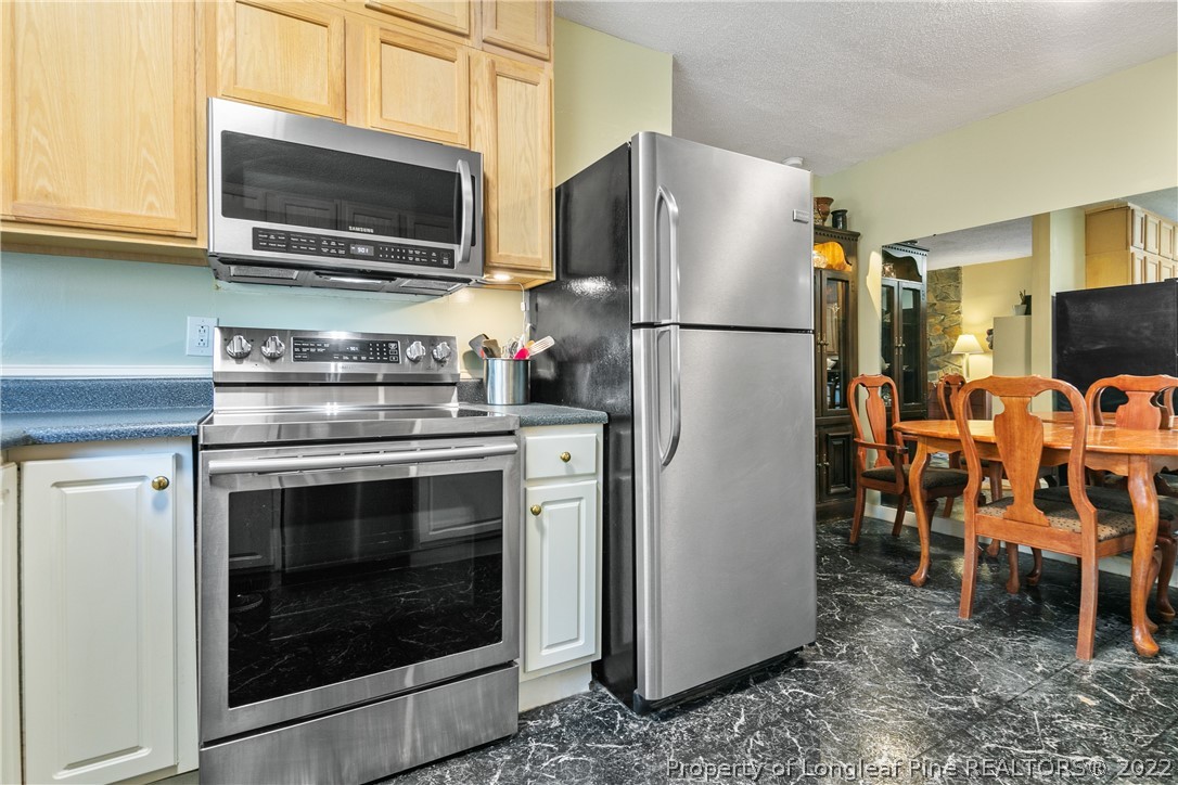 628 Tc Jones Road Raeford, NC 28376 - Photo 18 of 46 a kitchen with stainless steel appliances granite countertop a refrigerator stove and microwave
